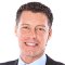 Professional man smiling in a suit and tie, specializing in Arizona commercial EV charging stations.