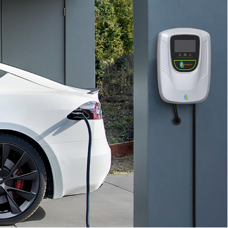 An electric vehicle parked and charging at a wall-mounted Level 2 charging station.