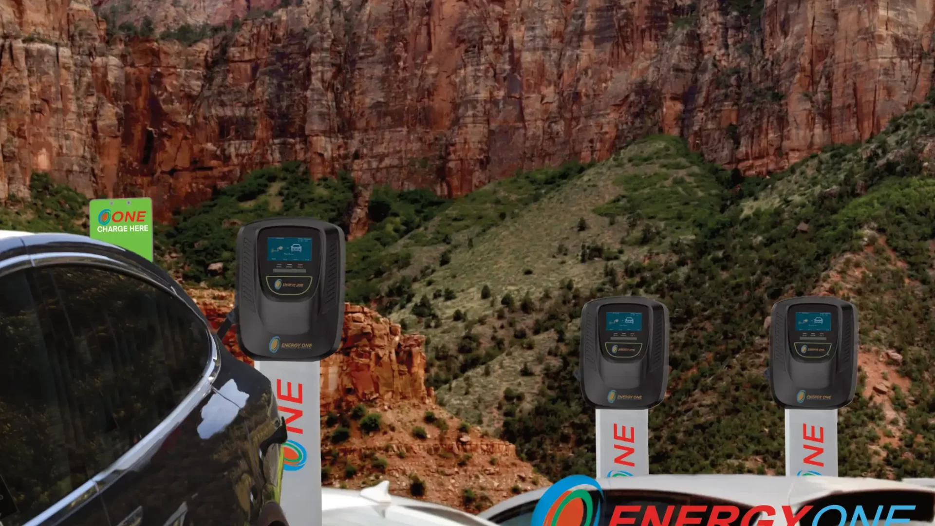 Electric cars parked at EV charging stations in a scenic mountainous area, with a prominent advertisement for Energy One charging service.