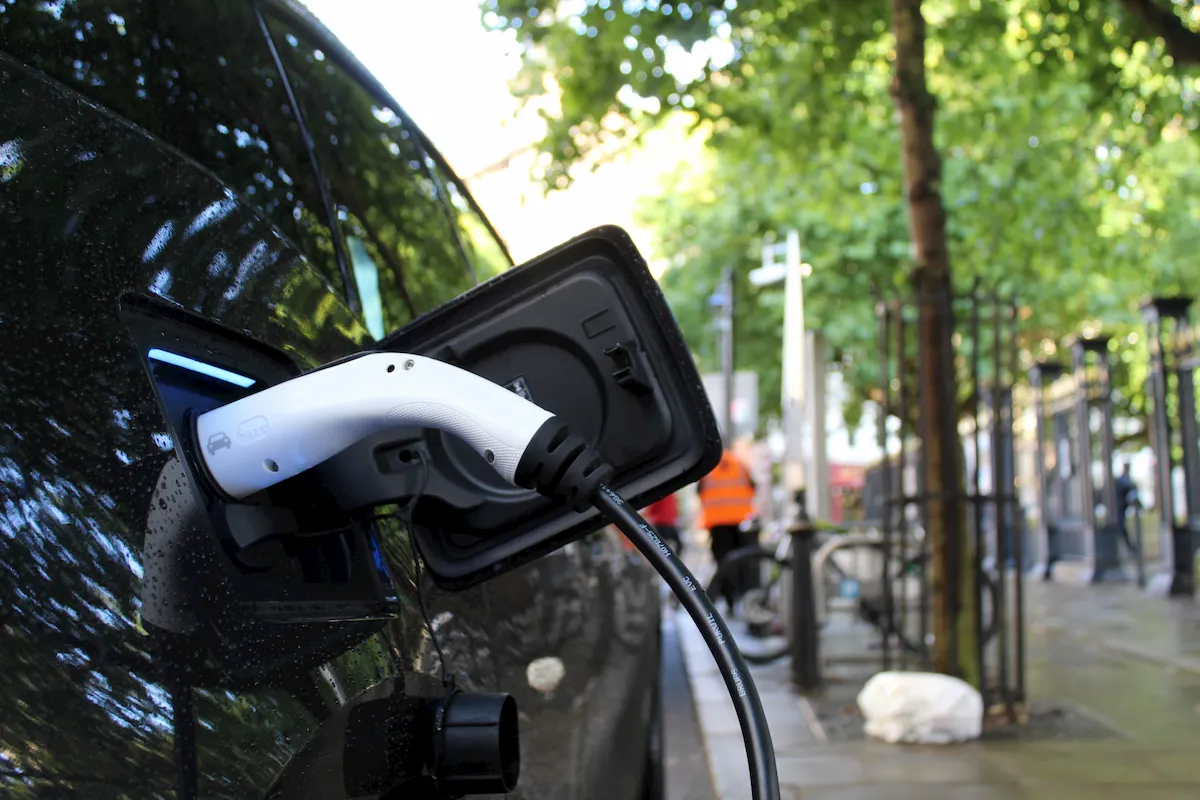 Electric vehicle being charged at a new public charging station.