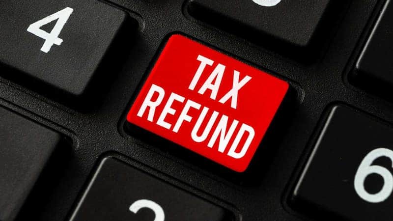 A red "tax credits" button on a black keyboard.