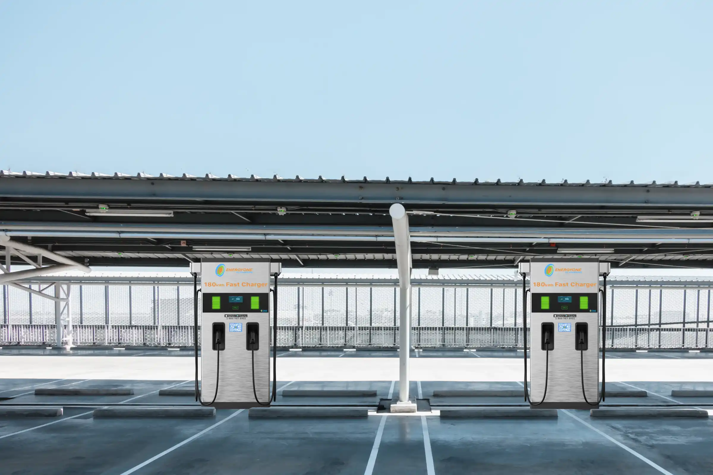 EV charging stations in a parking lot with solar panels overhead.