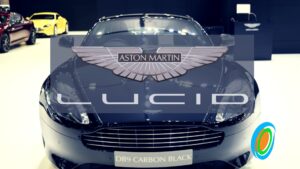 Luxury cars on display at an auto show with prominent branding visible.