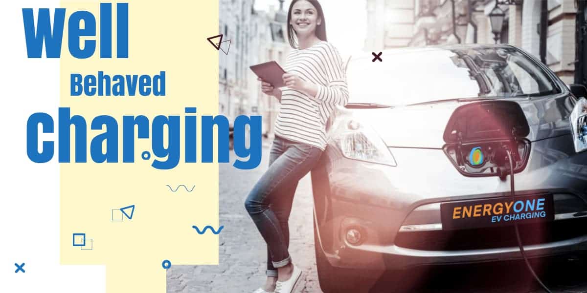 A woman smiling while using a tablet next to an electric car that is charging, with the stylized words "well behaved charging".