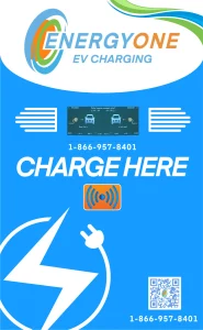 Bright blue EnergyOne EV charging station with company logo, contact number, and a QR code at the bottom. The text "CHARGE HERE" is prominently displayed along with wireless charging symbol.