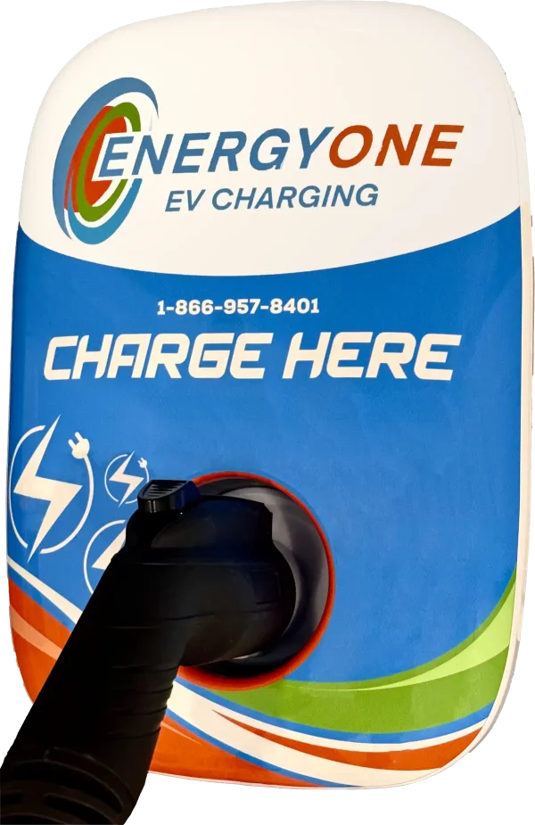 EnergyOne EV Level 2 Charging station with the text "1-866-957-8401" and "CHARGE HERE" displayed. A charging plug is partially inserted into the station.